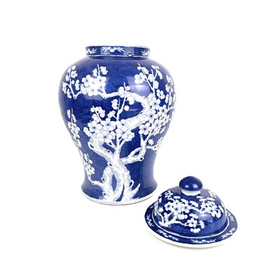 Lot 135 - A Chinese porcelain blue and white prunus pattern baluster vase and cover, 20th century