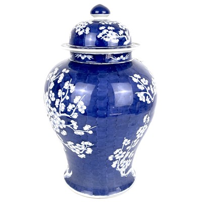 Lot 135 - A Chinese porcelain blue and white prunus pattern baluster vase and cover, 20th century