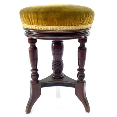 Lot 1833 - A Victorian walnut revolving piano stool,...