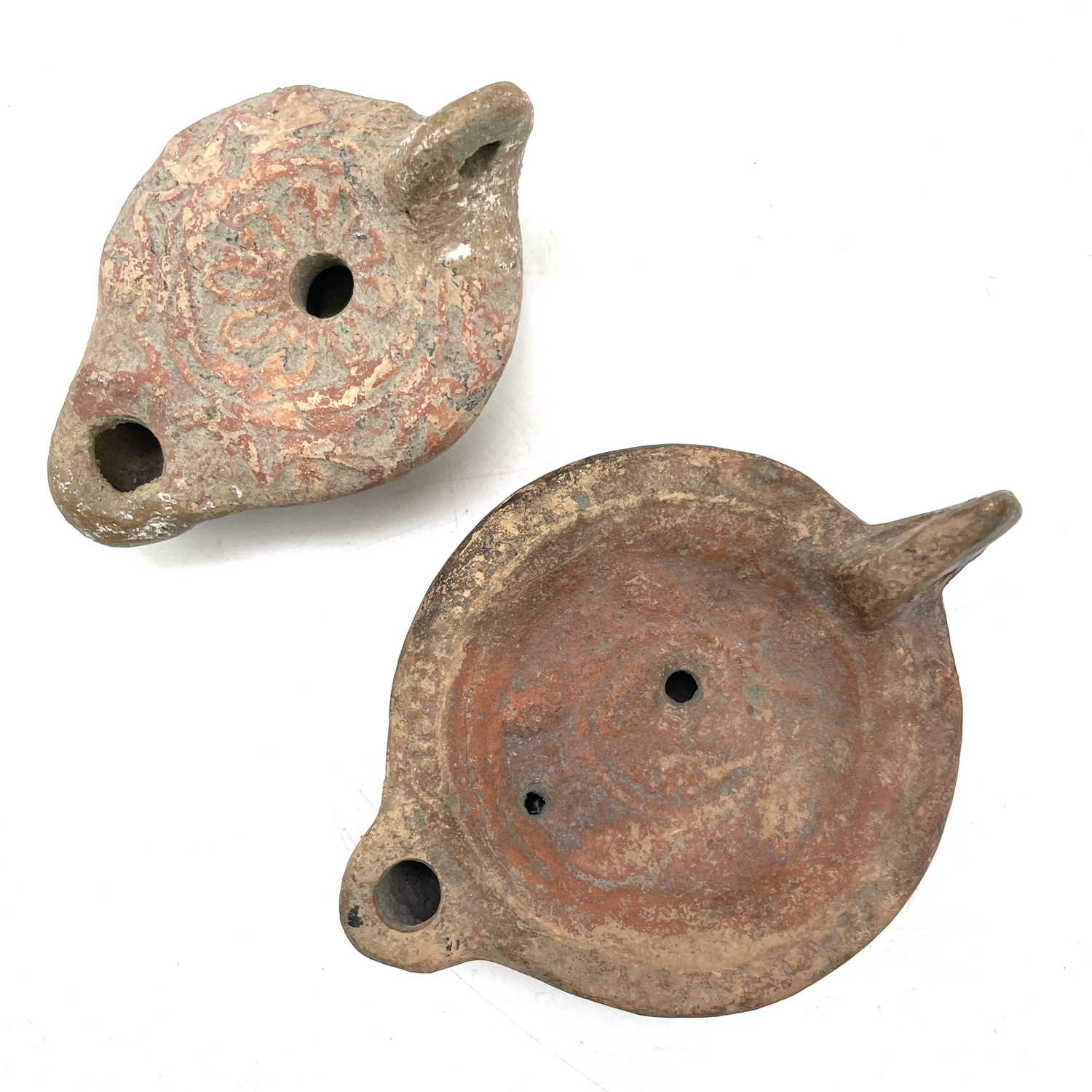 Lot 41 - A Roman terracotta oil lamp moulded with wheat...