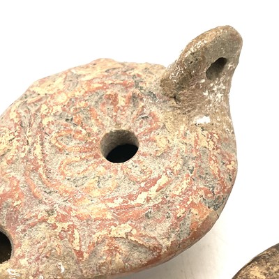Lot 41 - A Roman terracotta oil lamp moulded with wheat...