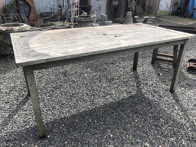 Lot 603 - A teak garden table.