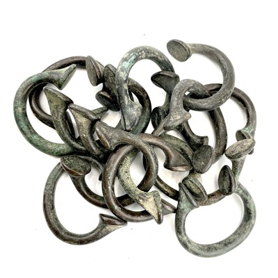 Lot 269 - A collection of fourteen manilla bangles.