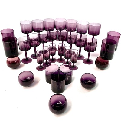 Lot 939 - A part suite of amethyst table glassware, mid...