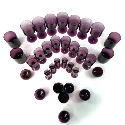 Lot 939 - A part suite of amethyst table glassware, mid...