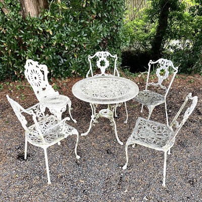 Lot 613 - A cast metal garden table and five chairs in...