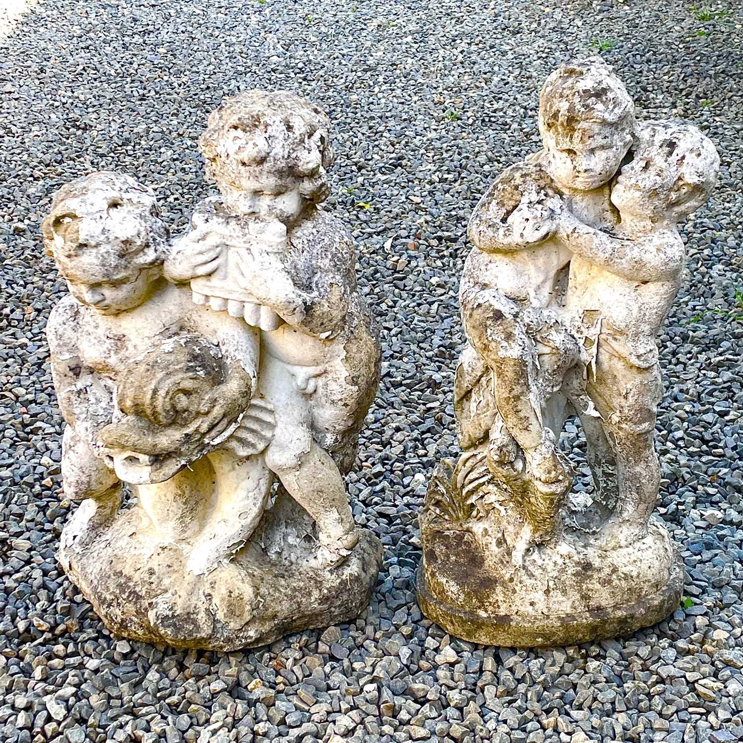 Lot 605 - A reconstituted stone fountain, modelled as putti playing pan pipes.