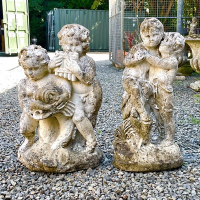 Lot 605 - A reconstituted stone fountain, modelled as putti playing pan pipes.