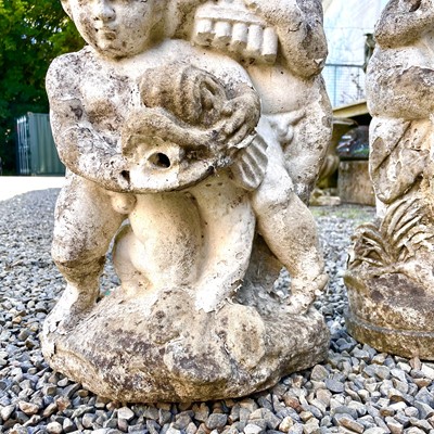 Lot 605 - A reconstituted stone fountain, modelled as putti playing pan pipes.