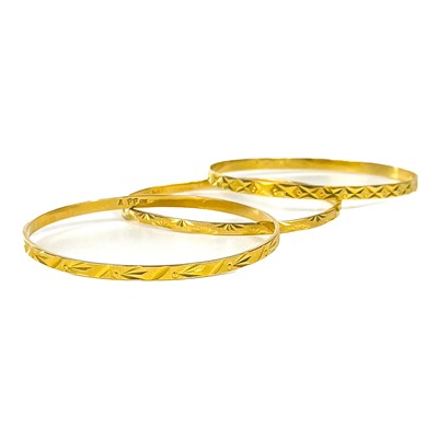 Lot 73 - A set of three Indian 21ct gold bangles.