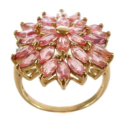 Lot 84 - A contemporary 9ct padparadscha sapphire and diamond cluster dress ring.