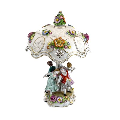 Lot 836 - A German porcelain figural flower encrusted table lamp and shade.