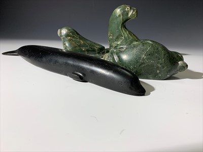 Lot 165 - Three Inuit soapstone carvings of seals,...