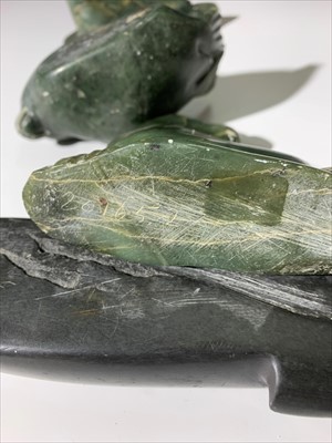 Lot 165 - Three Inuit soapstone carvings of seals,...