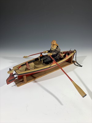 Lot 163 - A carved wood model of a fisherman and boat...