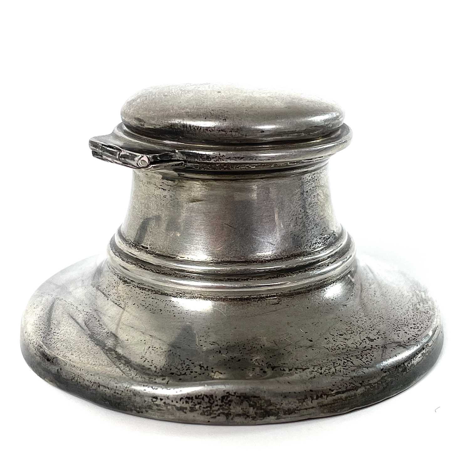 Lot 56 - An Edwardian silver capstan inkwell.