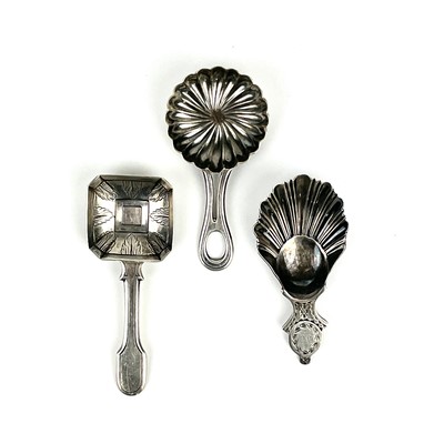 Lot 57 - A George V silver caddy spoon with shell bowl and two continental silver caddy spoons.