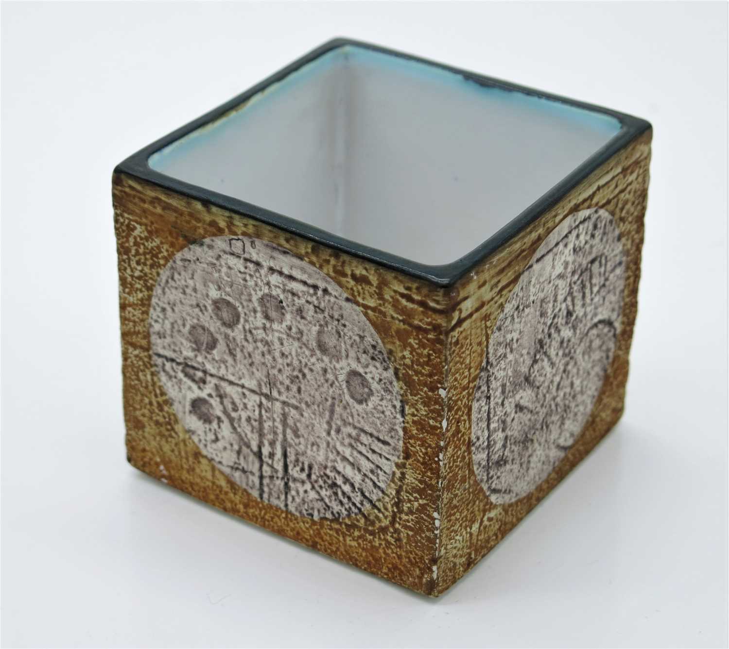 Lot 1329 - A Troika cube vase, the orange body with pale...