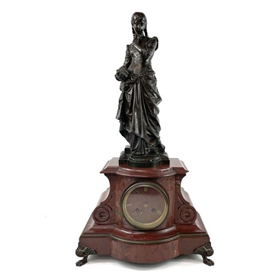 Lot 1719 - A 19th century French red marble mantle clock with a bronze figure of girl holding a small casket