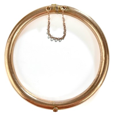 Lot 255 - A 9ct rose gold hollow hoop hinged bangle.