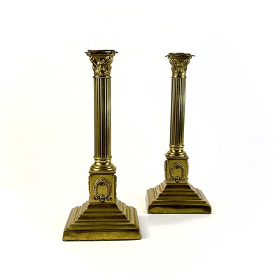 Lot 260 - A pair of brass Corinthian column candlesticks.