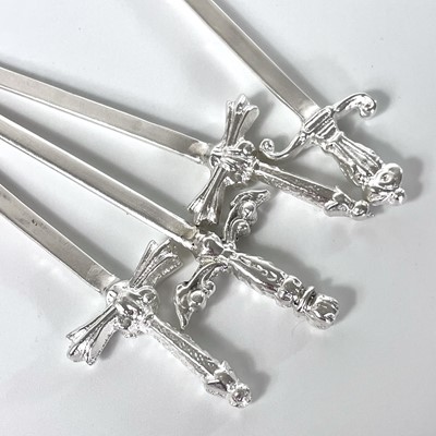 Lot 327 - Contemporary .999 fine silver 'Sword in the stone' picks by James Suddaby.