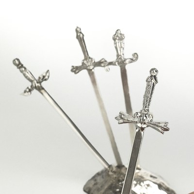 Lot 327 - Contemporary .999 fine silver 'Sword in the stone' picks by James Suddaby.