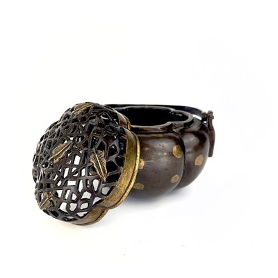 Lot 69 - A Chinese bronze hand warmer / portable incense burner, 19th century or earlier.