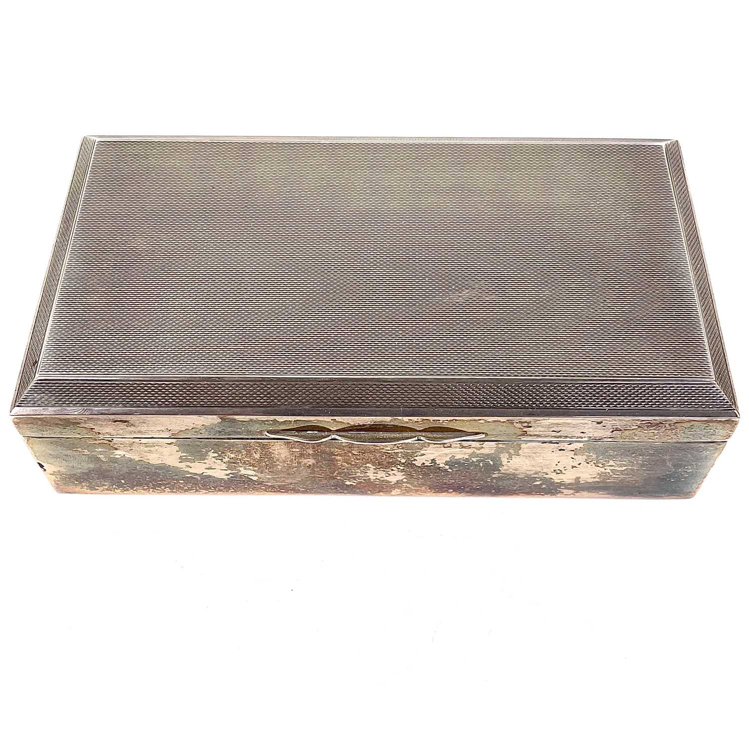 Lot 54 - A George VI silver Art Deco cigarette box.