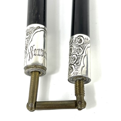 Lot 217 - An Edwardian silver mounted ebonised folding conductors baton.