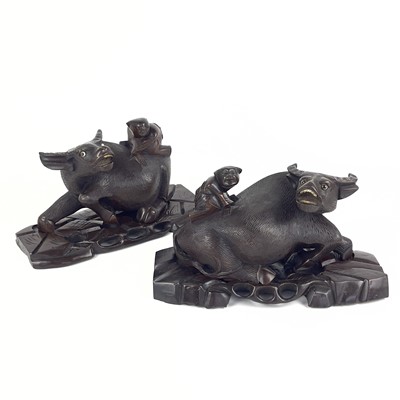 Lot 170 - A pair of Chinese carved hardwood buffaloes, with original stands, circa 1900.