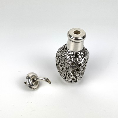 Lot 203 - A Chinese silver cased glass perfume bottle, with prunus blossom decoration.