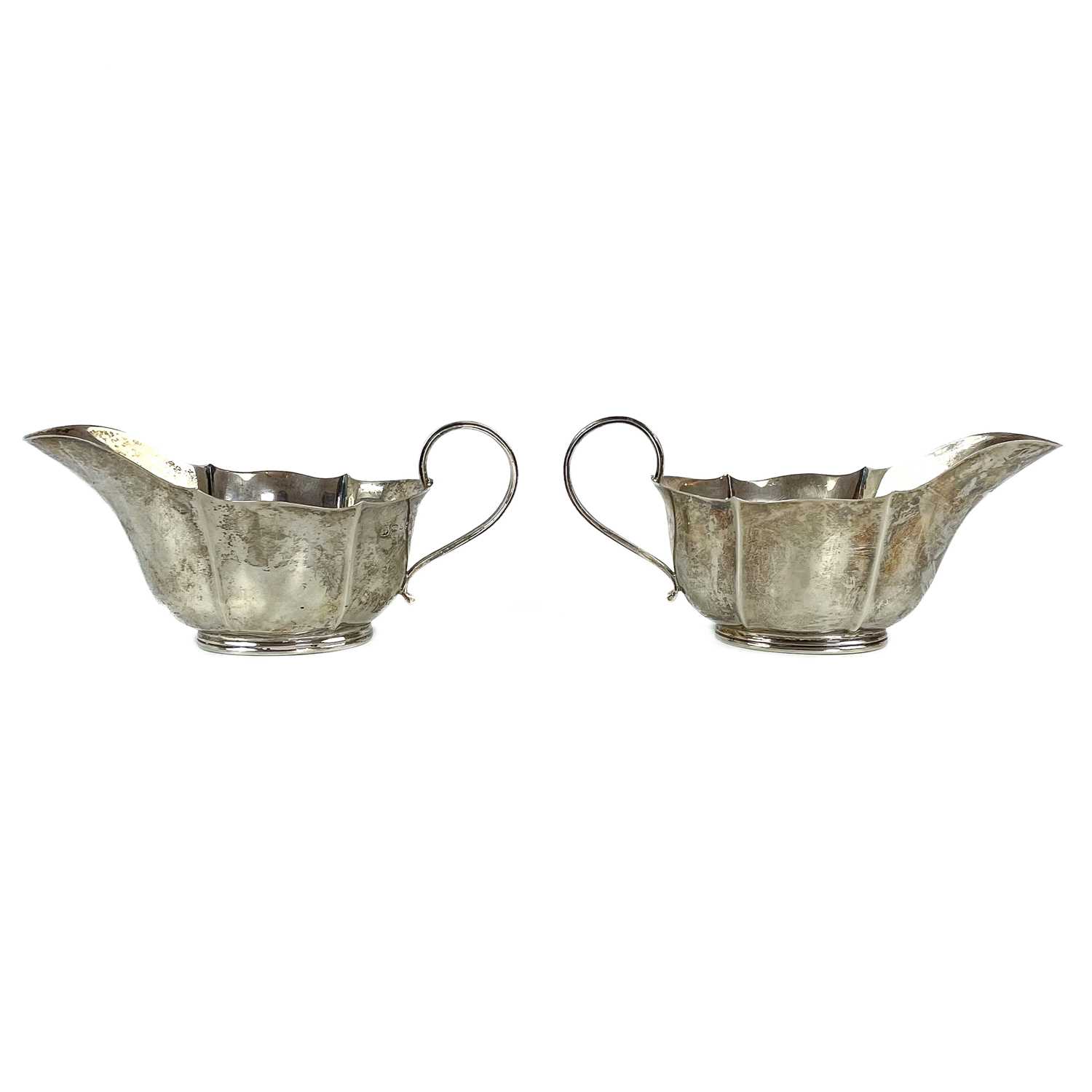 Lot 88 - A pair of George VI silver gravy boats.