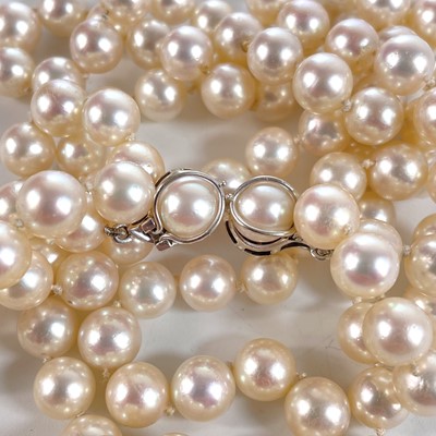 Lot 338 - A Swedish cultured pearl necklace with double 18ct white gold diamond and sapphire cluster clasps.