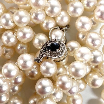 Lot 338 - A Swedish cultured pearl necklace with double 18ct white gold diamond and sapphire cluster clasps.