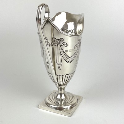 Lot 38 - A Victorian silver Adam style pedestal cream jug by George Fricker.