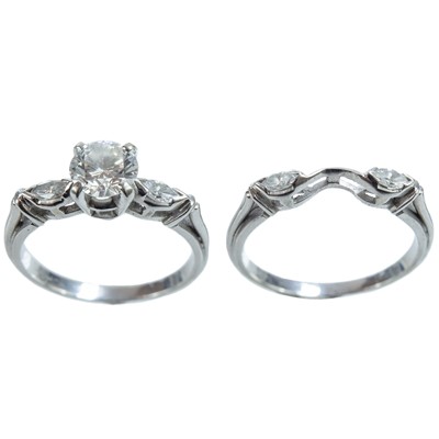 Lot 304 - An 18ct white gold 'Bridal Knot' pair of diamond rings by Peerless.