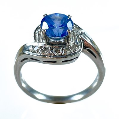 Lot 257 - A modern 14k white gold sapphire and diamond ring.