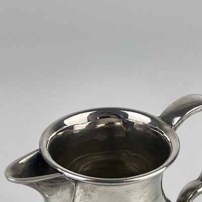 Lot 24 - A George V silver cream jug by Charles & Richard Comyns.