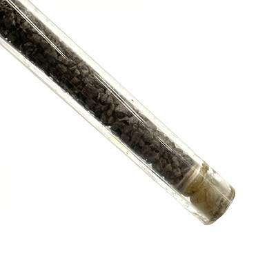 Lot 184 - A modern glass boiler tube displaying cassiterite at the various stages of processing.