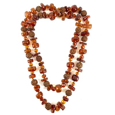 Lot 399 - A Baltic amber and nut long bead necklace.