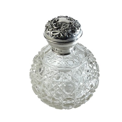 Lot 144 - An Edwardian silver lid cut glass scent bottle.