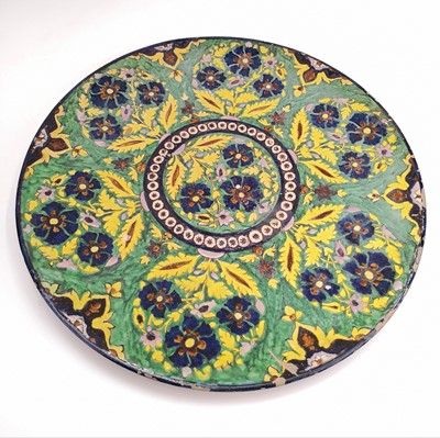 Lot 1017 - A large Persian pottery charger, circa 1900.