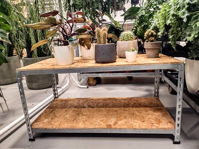 Lot 350 - An industrial wooden and metal display table,...