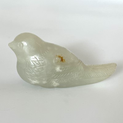Lot 10 - A Chinese pale jade and russet carved bird, Qing Dynasty.