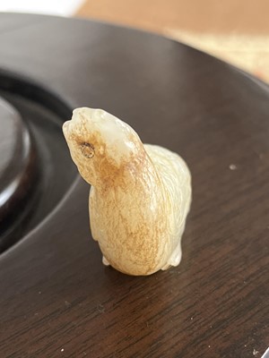 Lot 11 - A Chinese carved jade and russet chicken, Qing Dynasty.