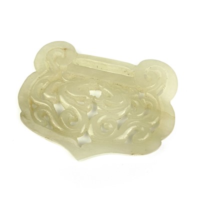 Lot 12 - A Chinese carved pale jade buckle, Qing Dynasty.