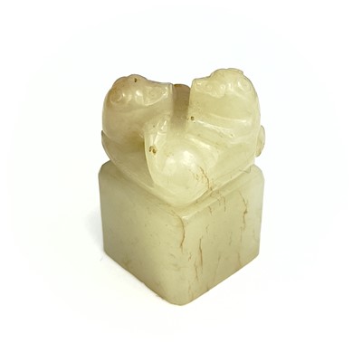 Lot 15 - A Chinese carved pale jade and russet seal, Qing Dynasty.