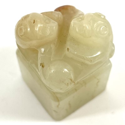 Lot 15 - A Chinese carved pale jade and russet seal, Qing Dynasty.