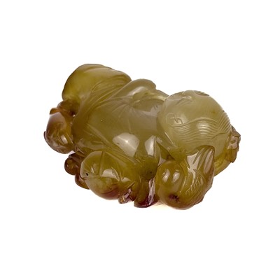 Lot 16 - A Chinese jade and russet carving of a boy, Qing Dynasty.